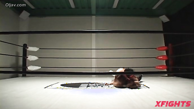 Akibacom - SRX-01 - Asian girl engaged in hardcore wrestling with a guy in the ring