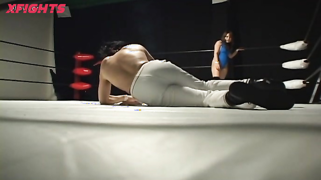 Akibacom - SRX-01 - Asian girl engaged in hardcore wrestling with a guy in the ring