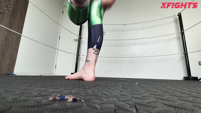 Fetish Machine Femme - The giantess shrinks her opponent in the ring